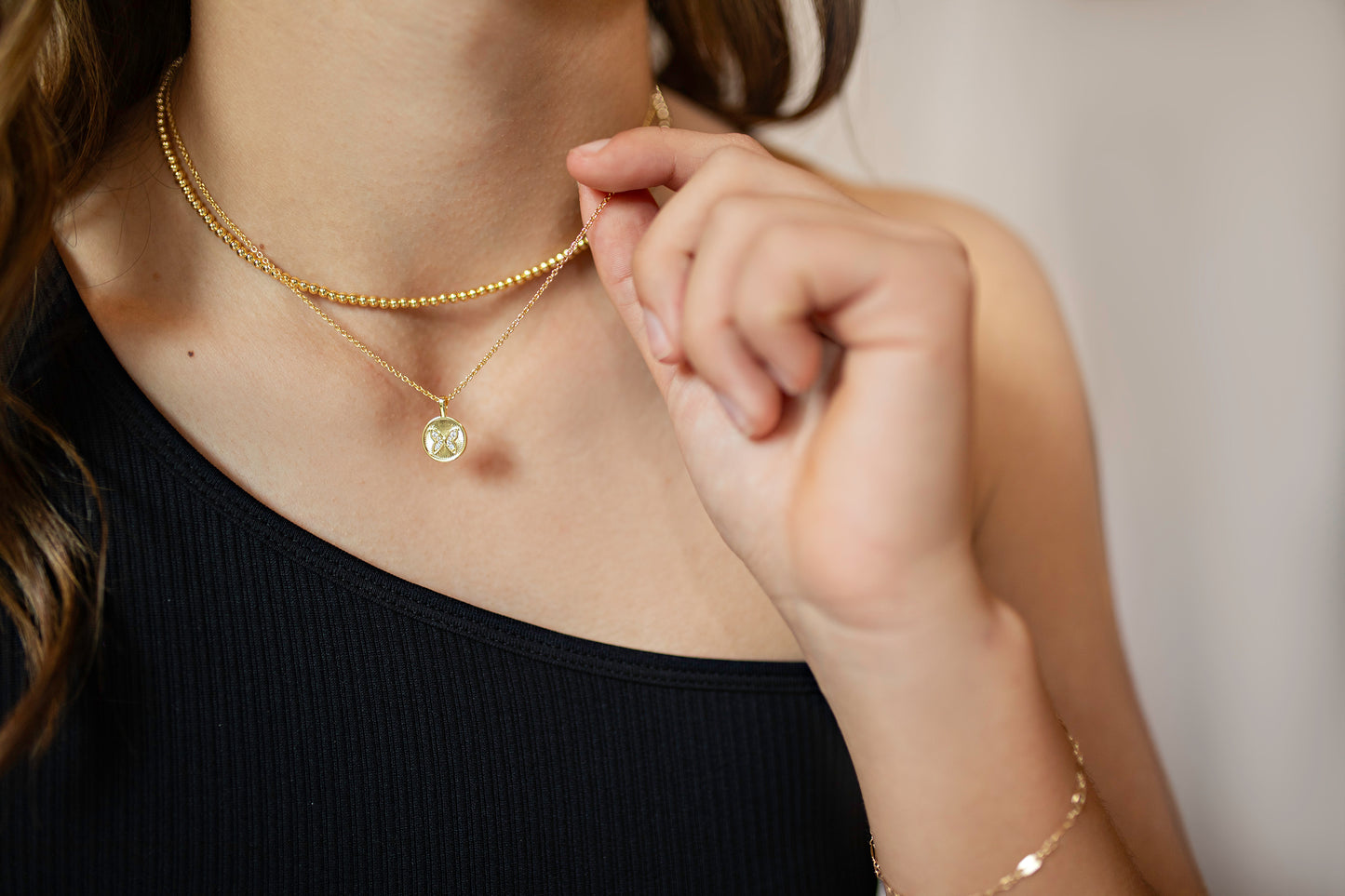 Gold bead and butterfly necklace