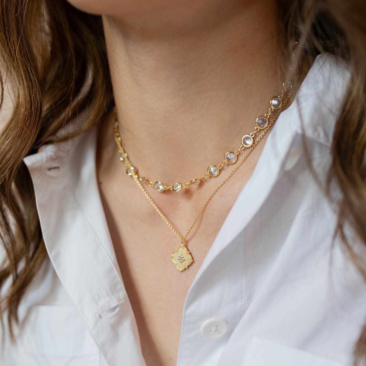 Gold sparkle necklace stack with white shirt