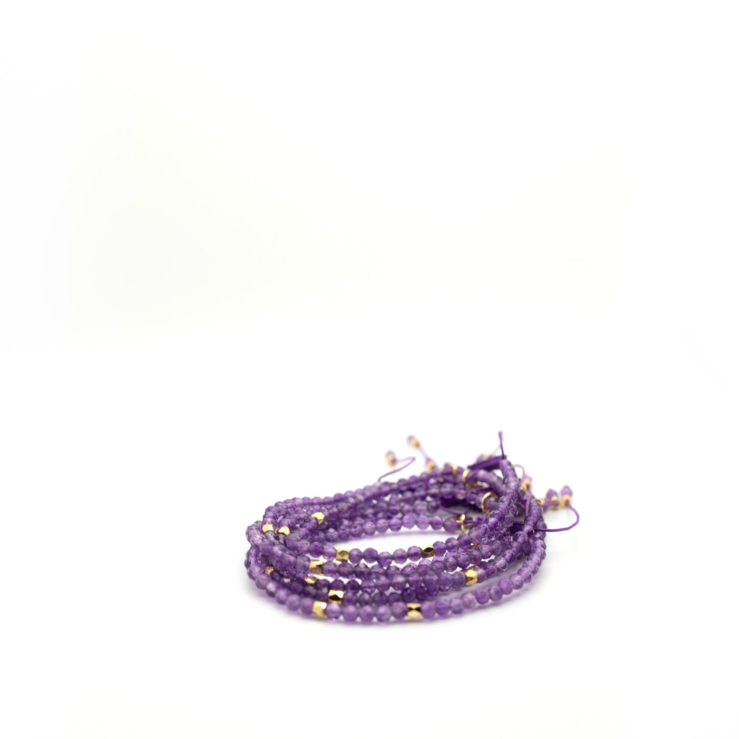 Purple bead bracelet with gold spacers and adjustable slider knot on purple string 