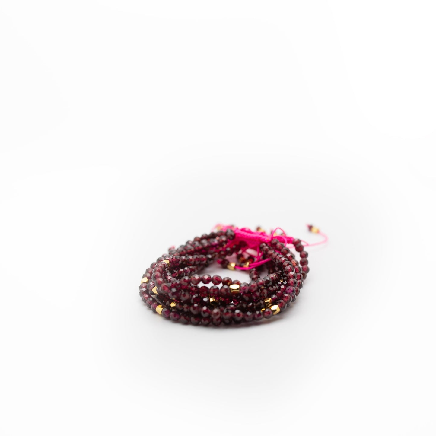 Marron garnent beads with gold accents with pink string 