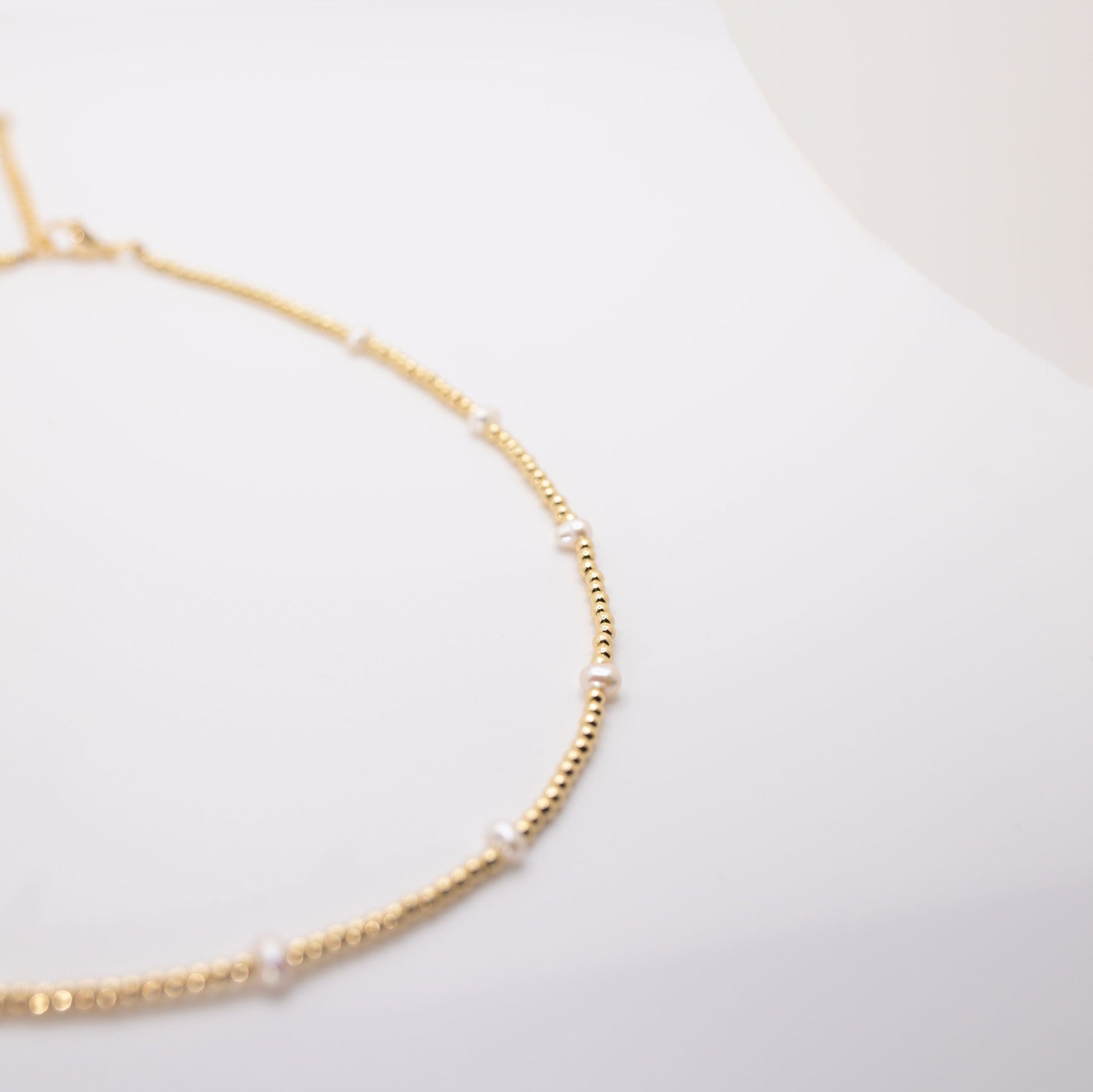 layering gold necklace with pearls