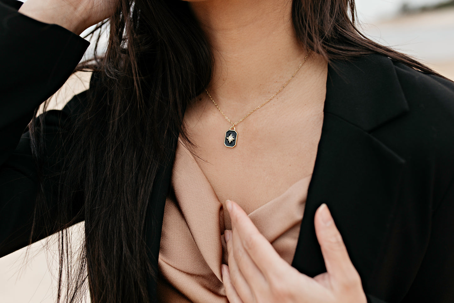 Women wearing a black star necklace