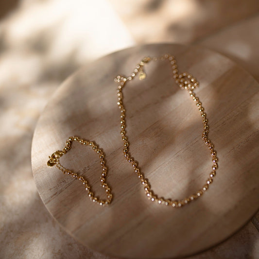 Gold Bracelet and Necklace Set on wood background