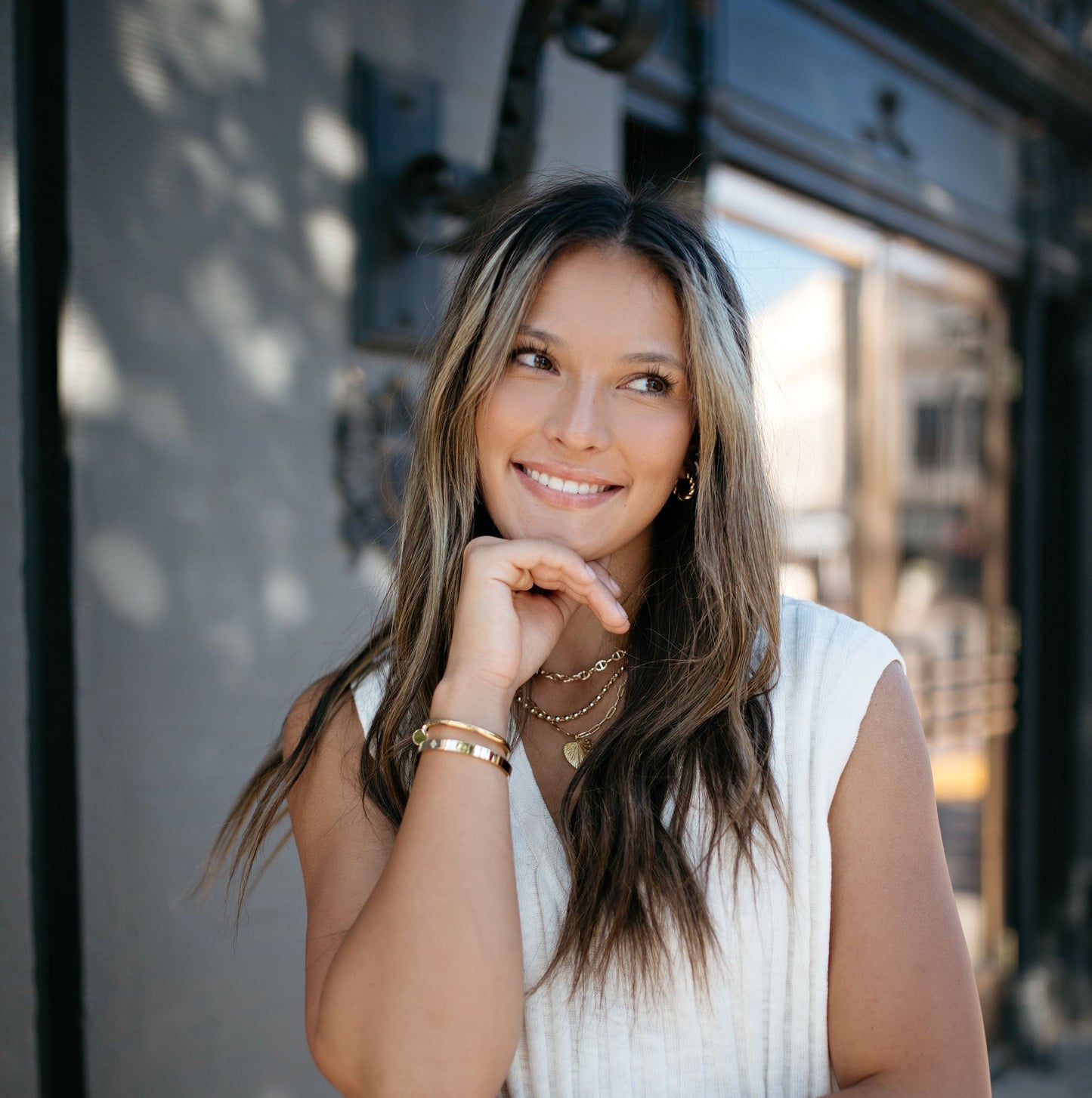 California Street in free people knitwear outfit with gold jewelry 