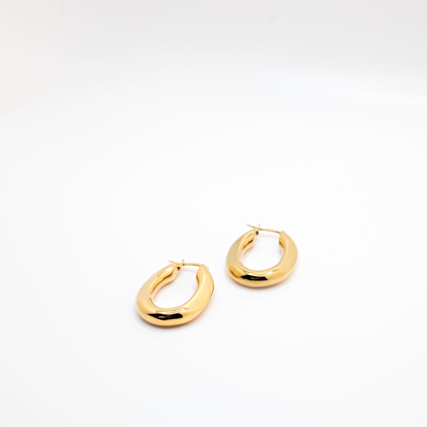 Gold hoop earrings in geometric shape