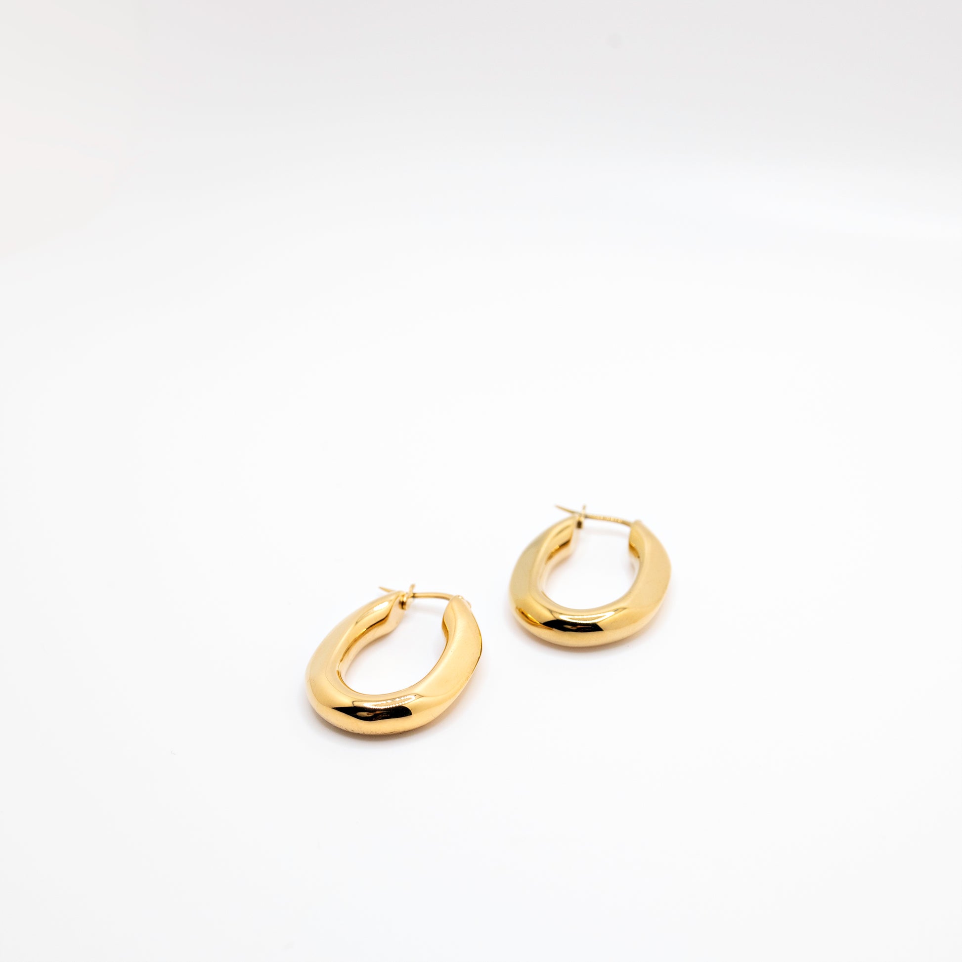 Gold hoop earrings in geometric shape