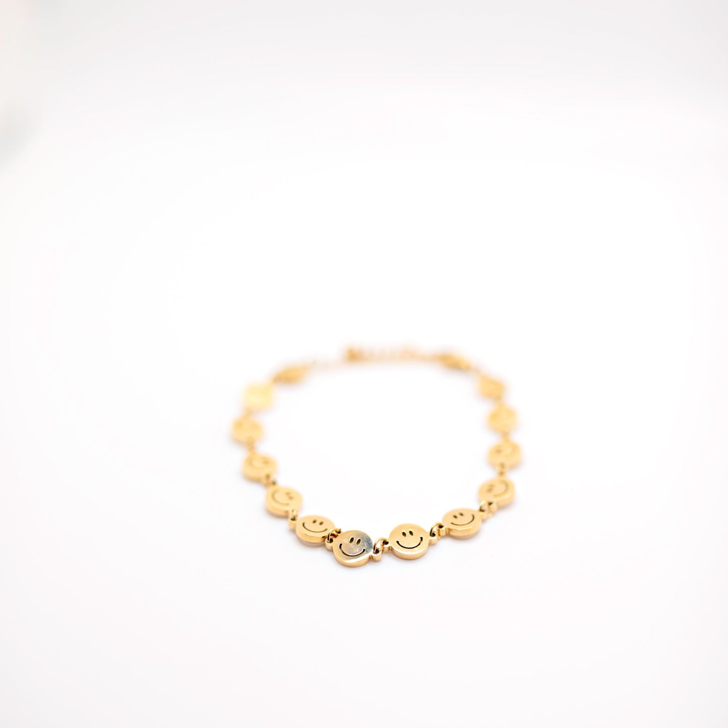 Gold smiley face charm bracelet