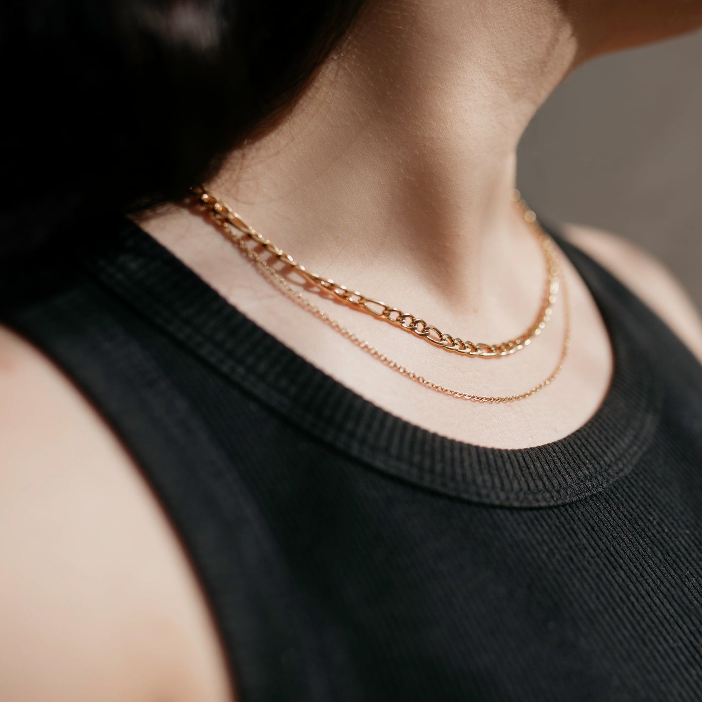 Two chain necklace in gold worn with casual outfit