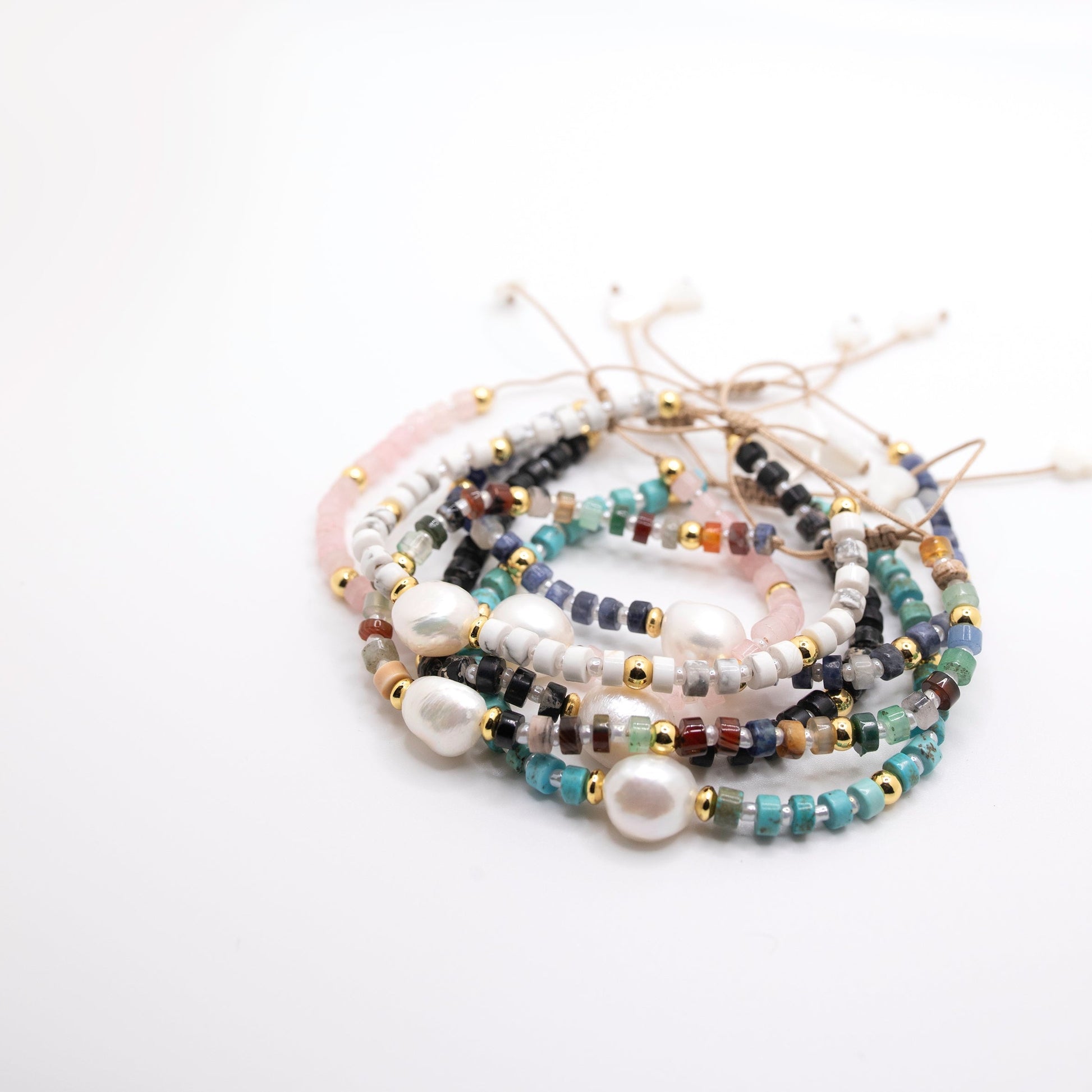 Stack of pearl and bead bracelets in lots of colors