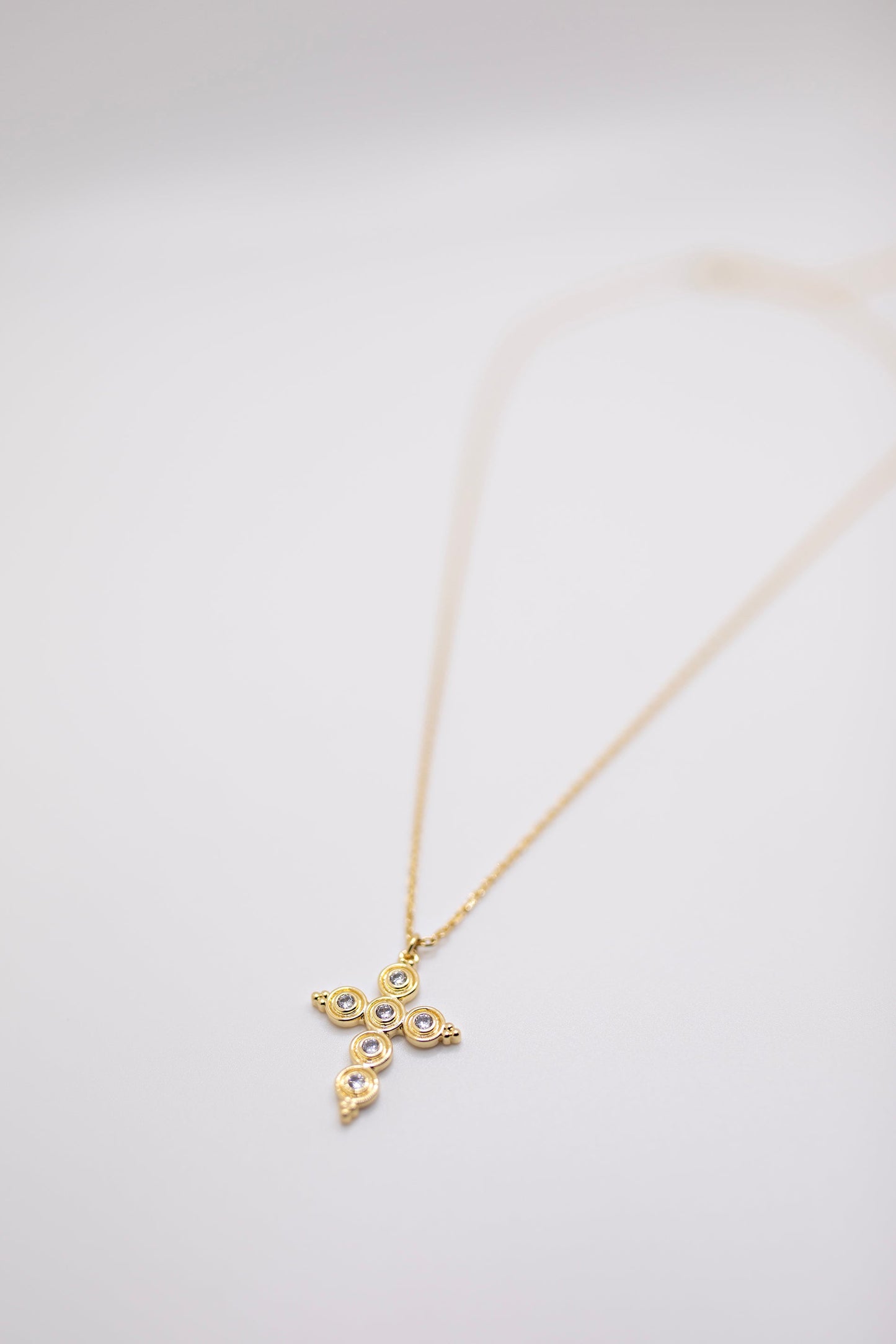 Gold cross with round crystals